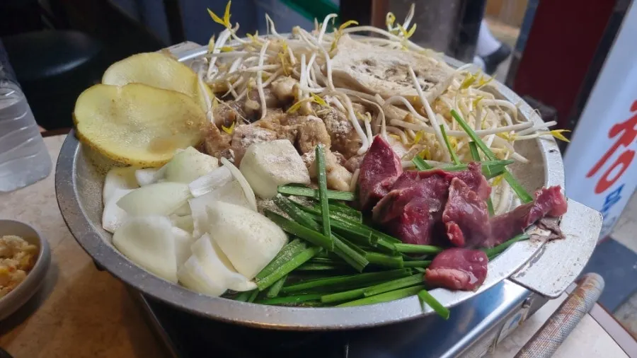 Mixed gopchang cooking on the grill
