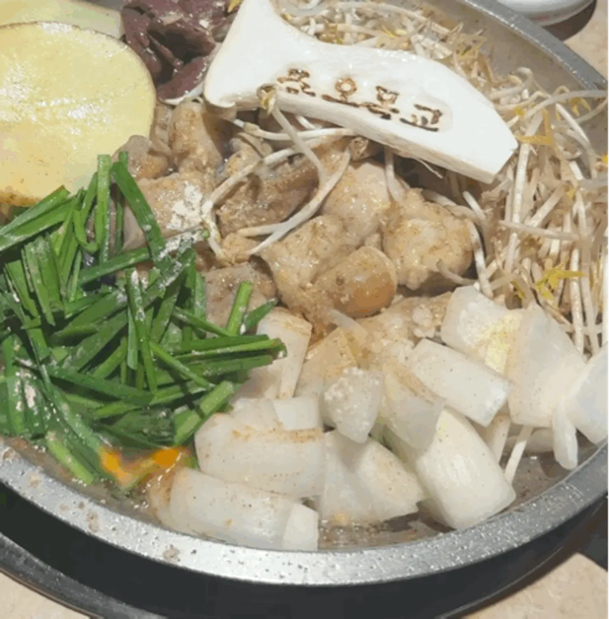 Mixed gopchang platter laid out on the grill