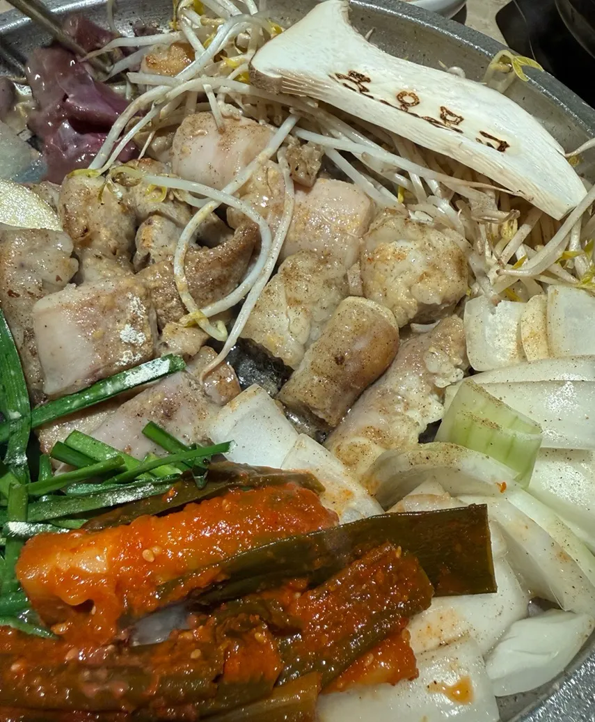 Scallion kimchi placed on the grill alongside the platter