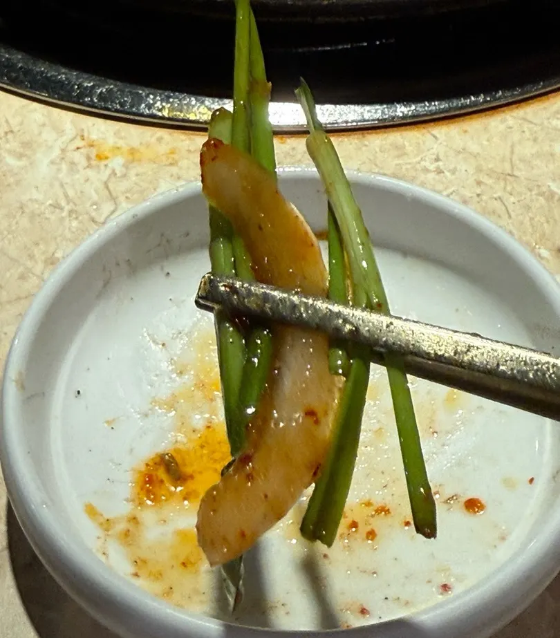 Hwangso gopchang dipped in sesame oil sauce