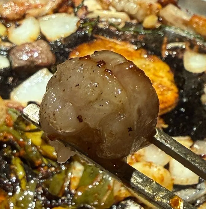 A piece of gopchang with chive salad