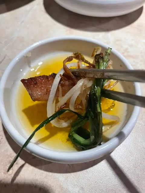 Gopchang and vegetables grilling to a golden brown on the grill