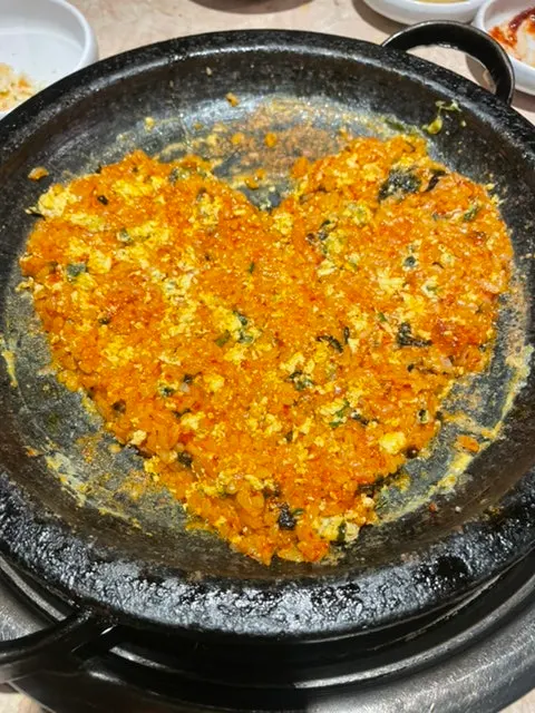 Fried rice being mixed with egg on the grill