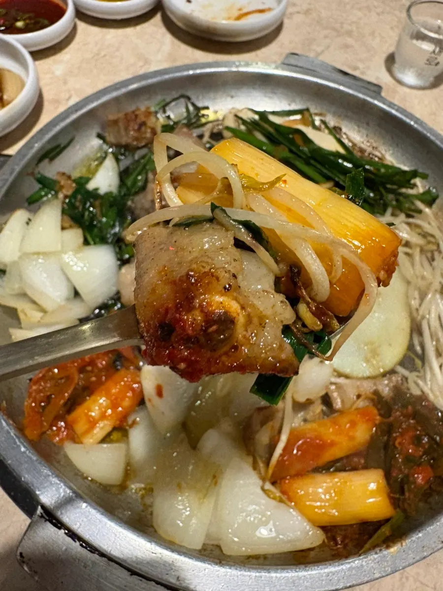 Gopchang skewered onto a whole scallion