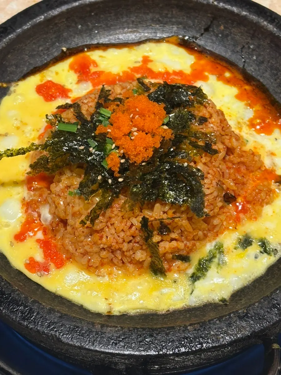 Gopchang fried rice being cooked with egg on top