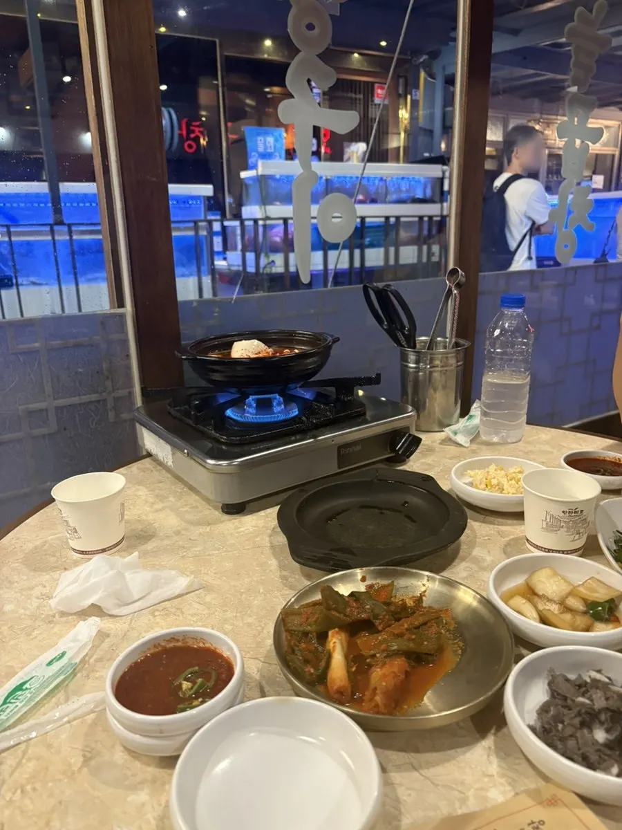 Table set with sundubu-jjigae and banchan