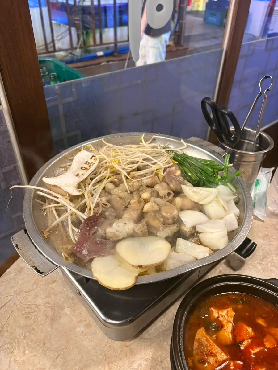 Gopchang and vegetables cooking on the grill