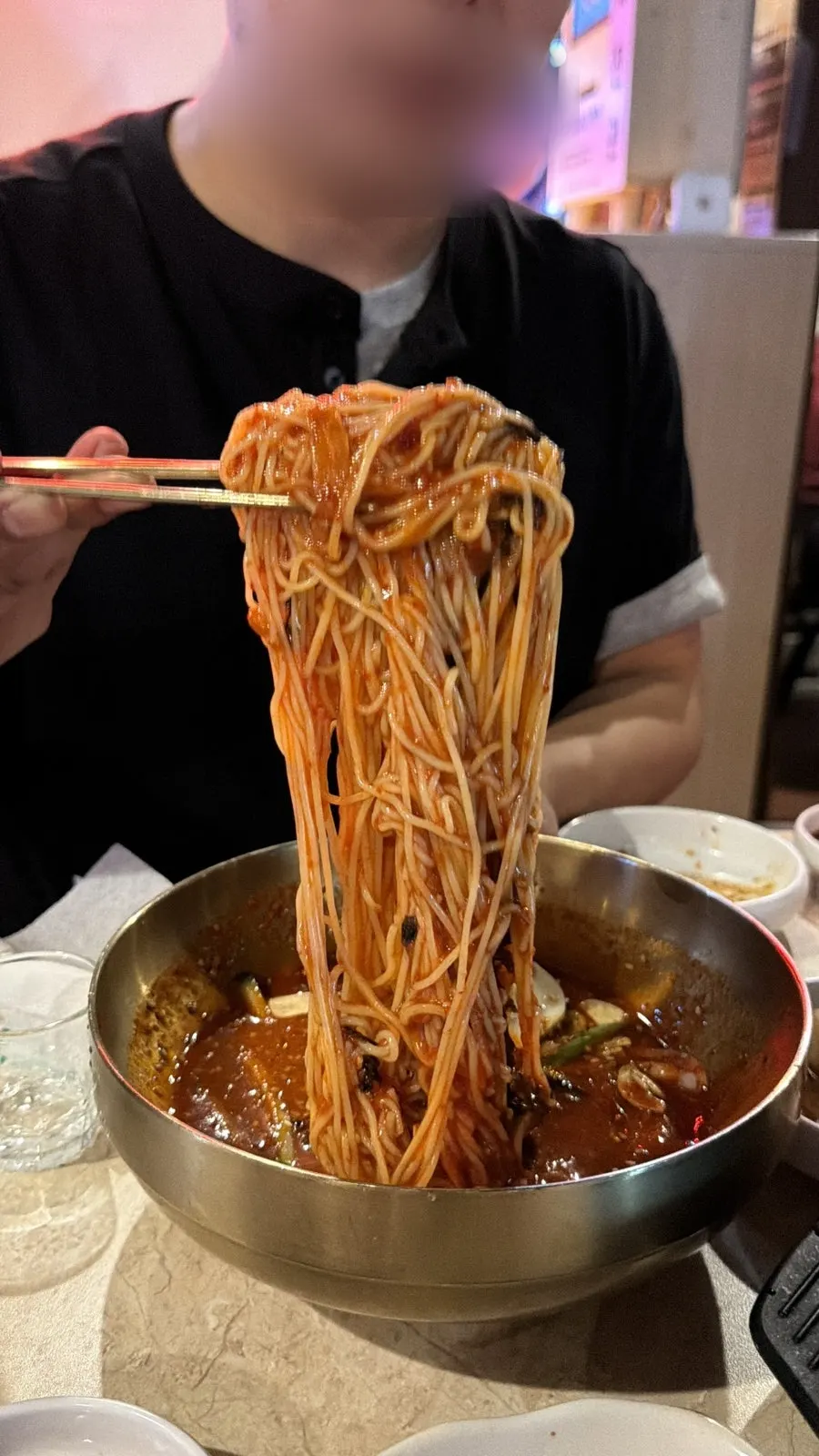 A bite of tangy-sweet seasoned bibim guksu