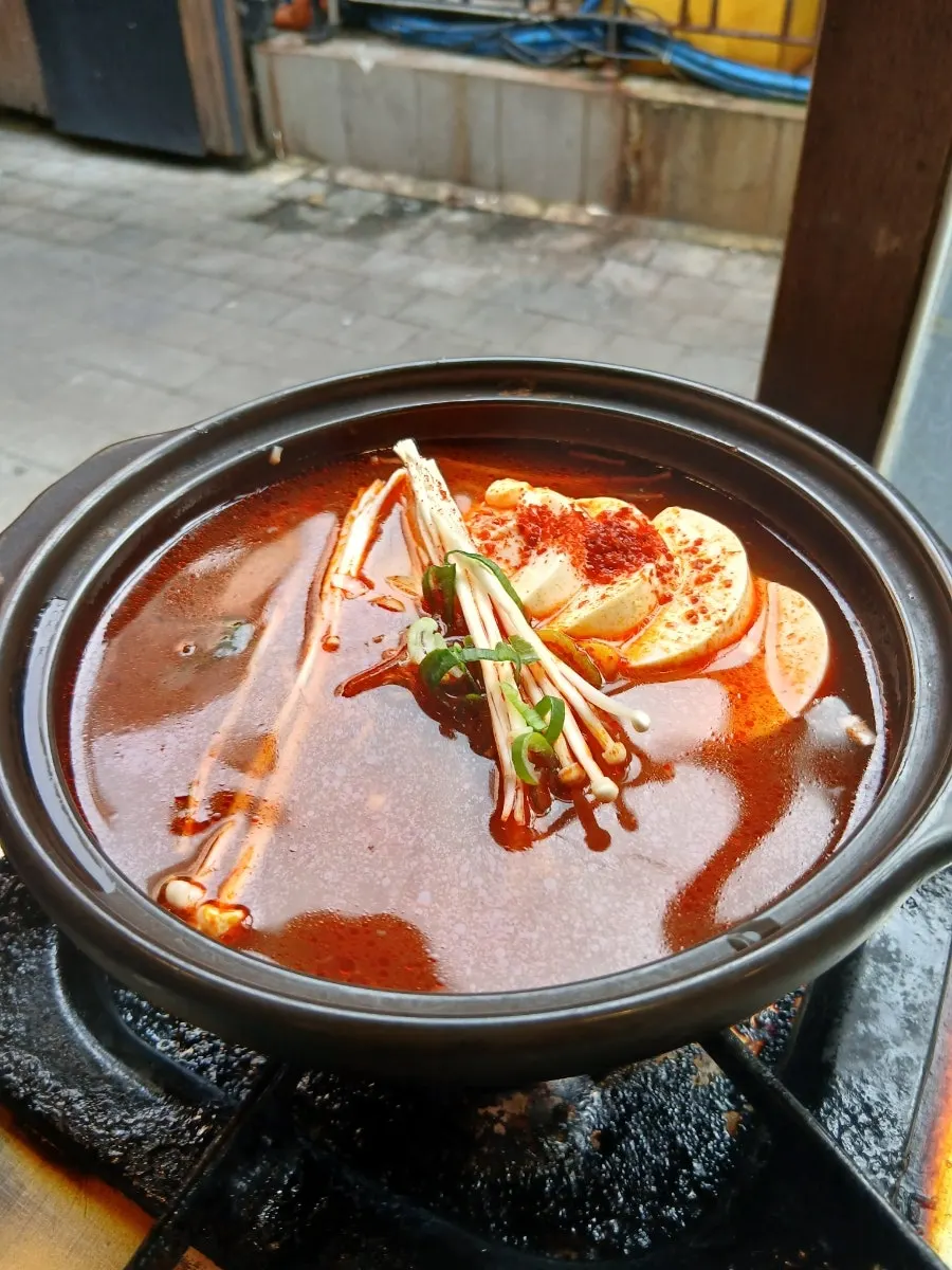 Complimentary spicy sundubu-jjigae served at the start