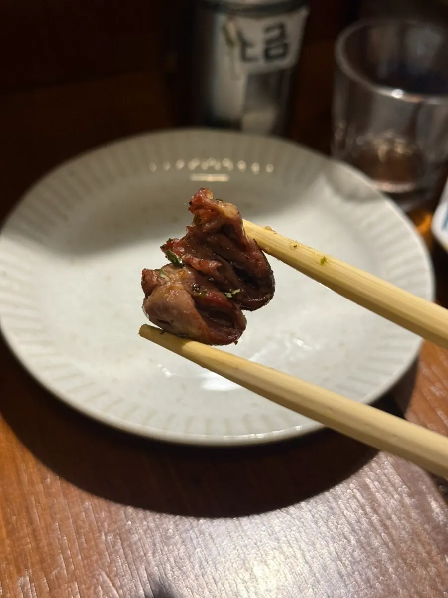 Chicken skewers enjoyed with a solo drink