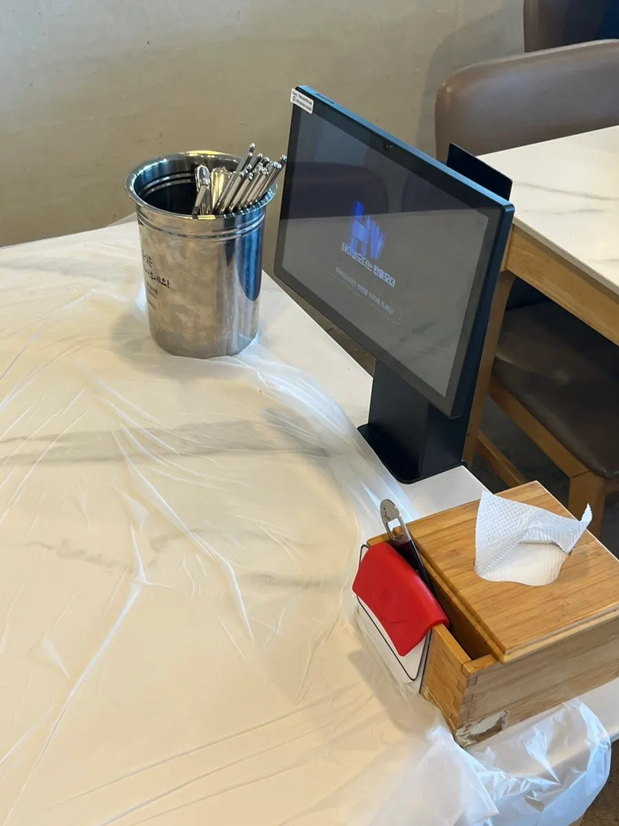 Table setting with small plate, utensils and paper cup