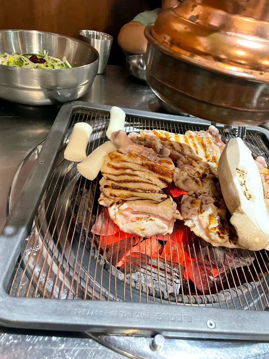 Chicken galbi grilling over charcoal