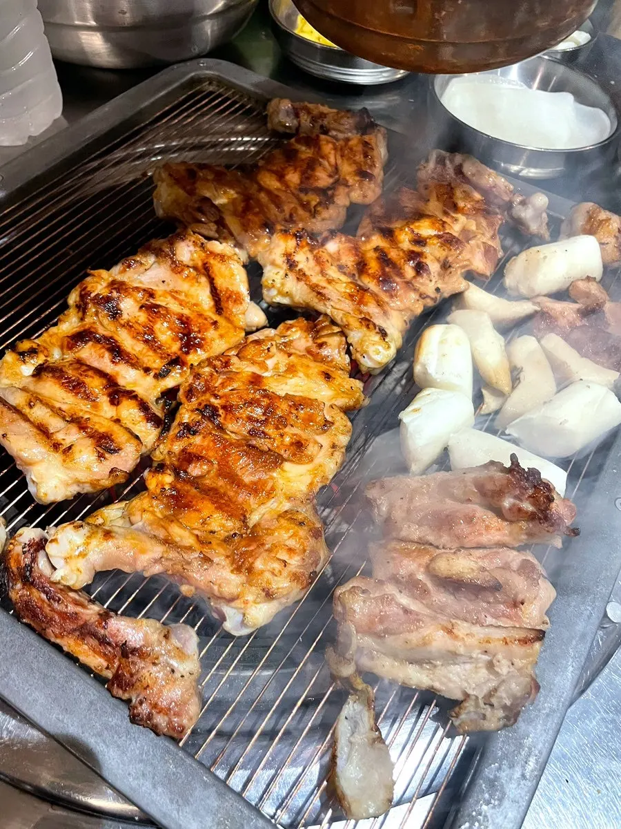 Soy sauce chicken galbi placed on the charcoal grill