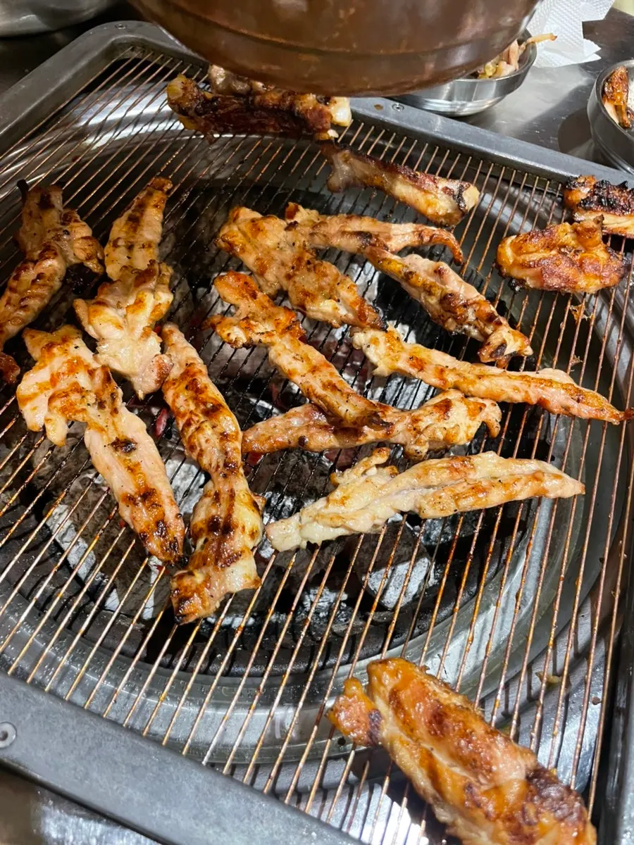 Plate of pre-seared grilled chicken neck meat