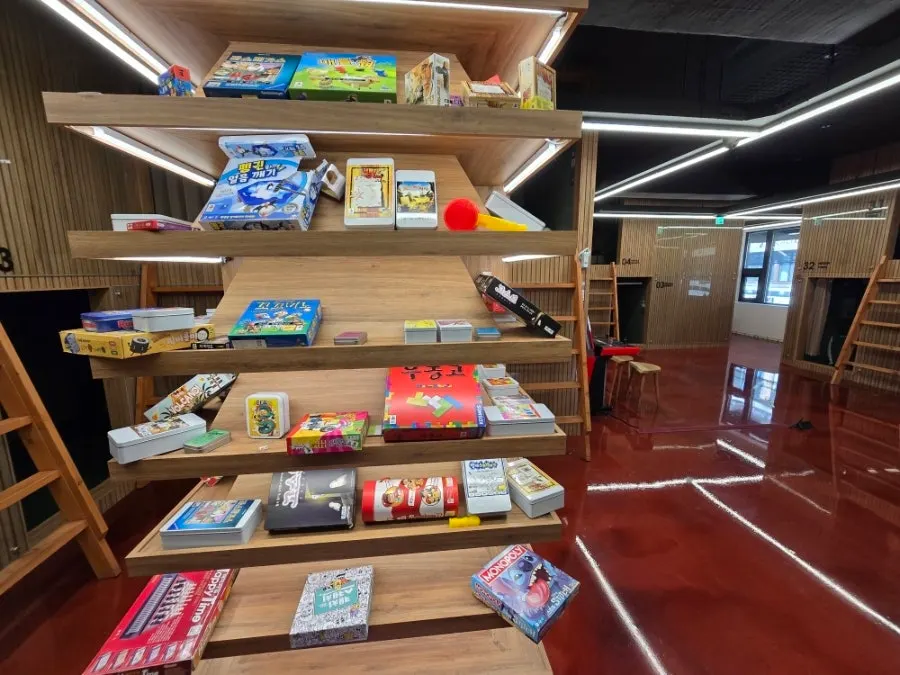 Board game boxes organized on shelves