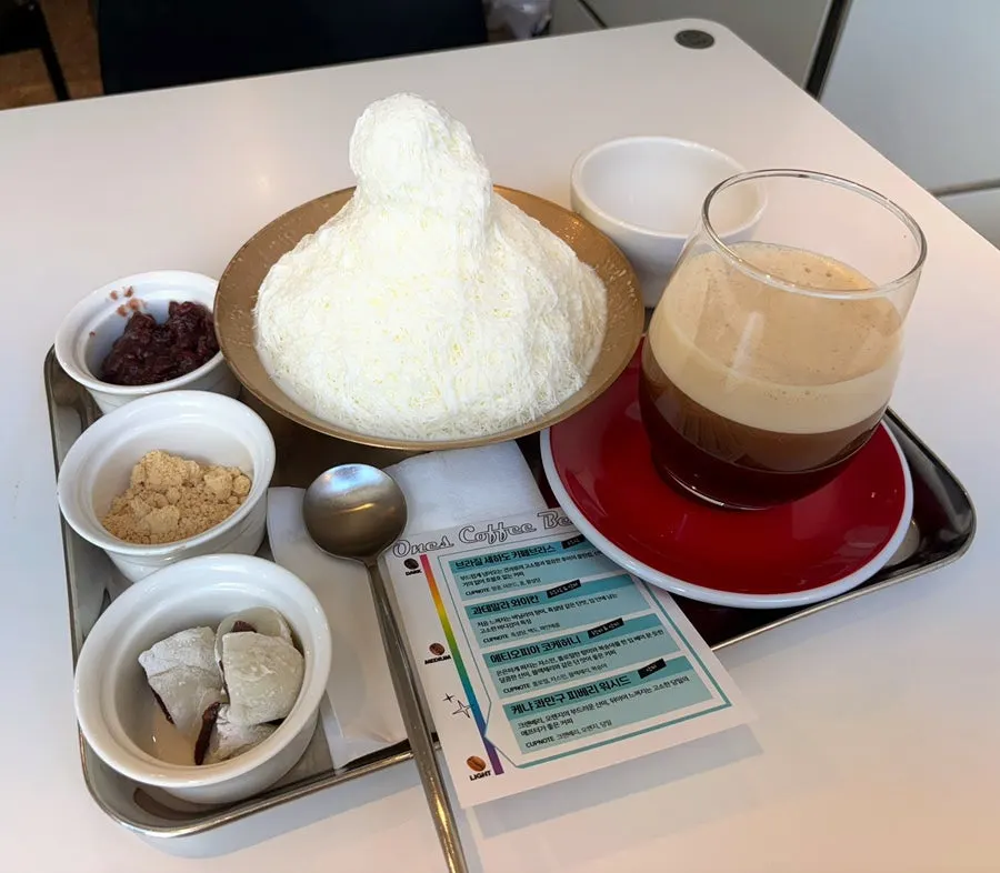 Table setting with ordered snowflake red bean bingsu and today's coffee