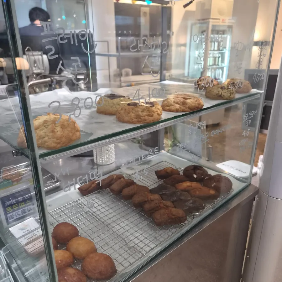 Display case with scones, cookies, and egg tarts