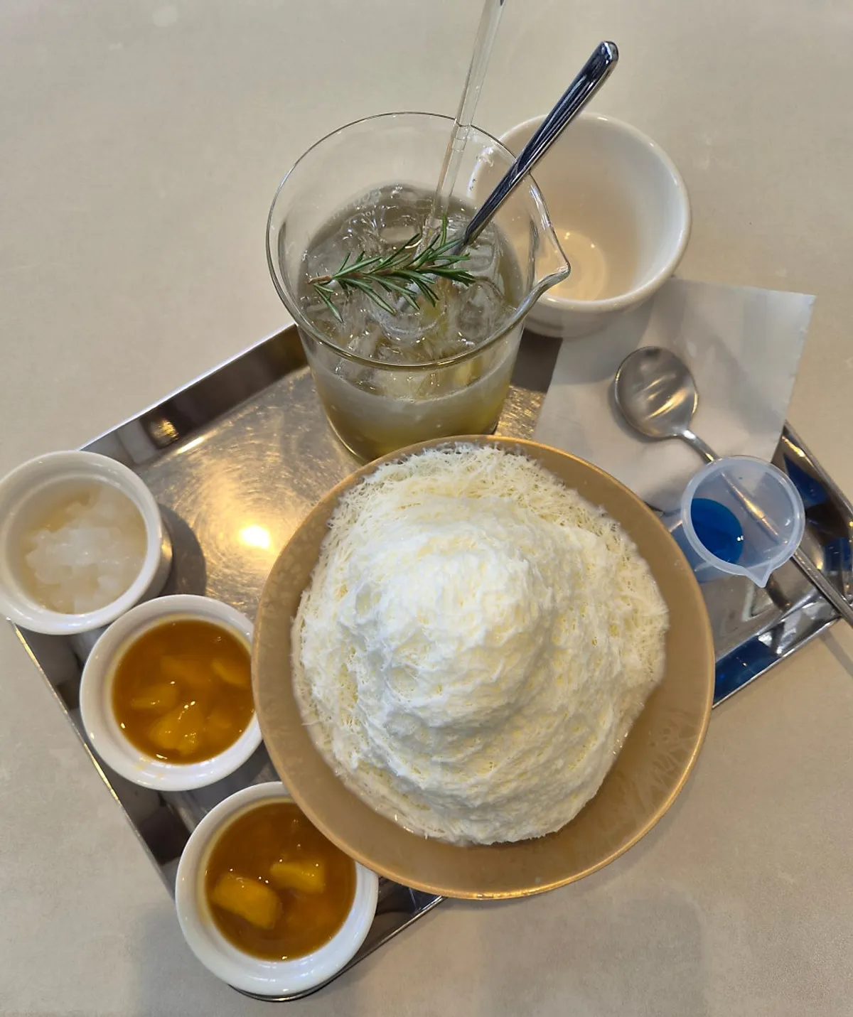 Wonz Coffee mango milk bingsu with toppings served separately