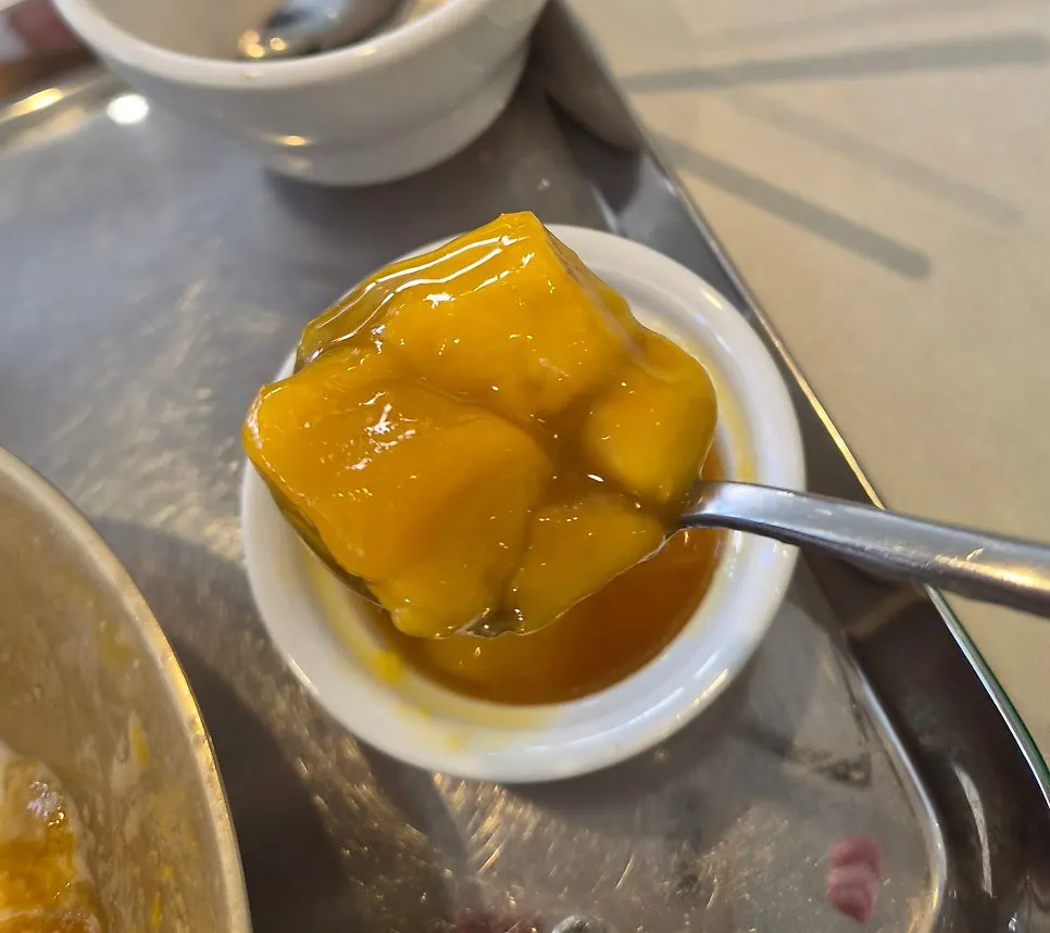 Plate of soft-textured mango topping
