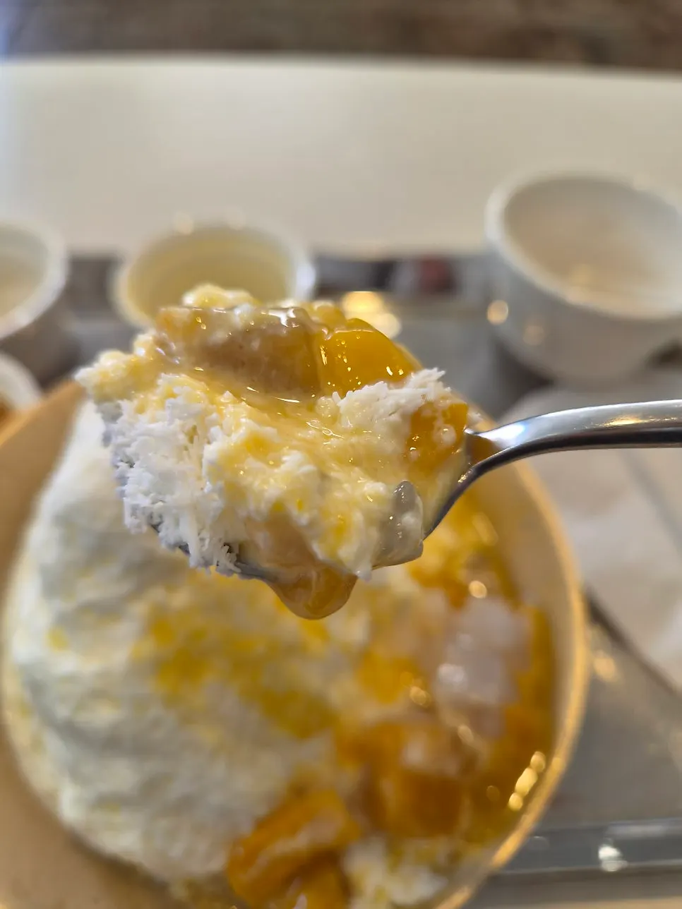 A spoonful of mango on top of milk bingsu