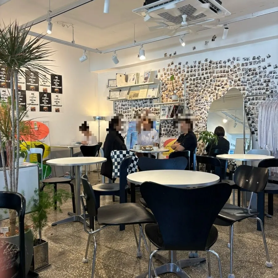 Interior of Wonz Coffee with two-person tables and sofa seats