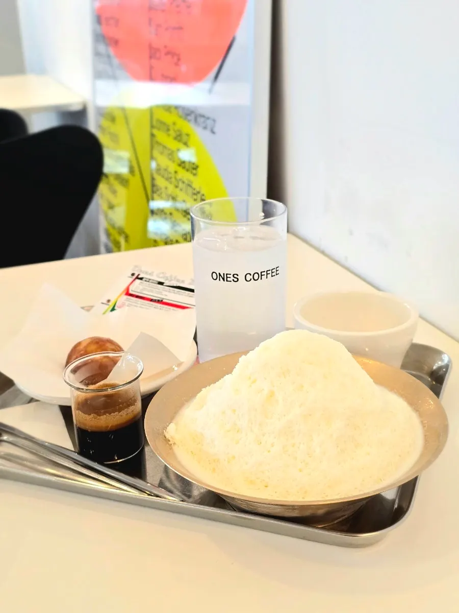Table set with coffee, bingsu, and desserts together