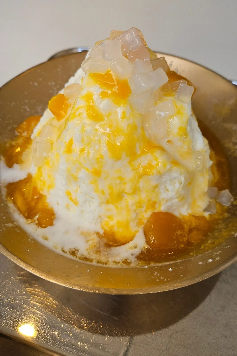Snowflake milk ice topped with mango syrup