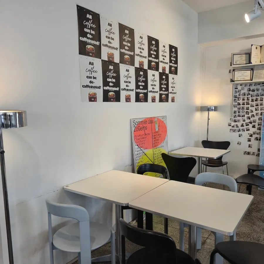 Wall filled with black-and-white photos and posters