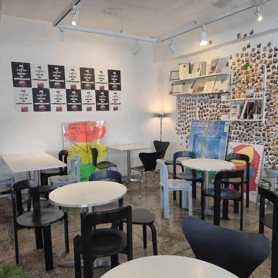 Space with art posters, frames, books, and plants