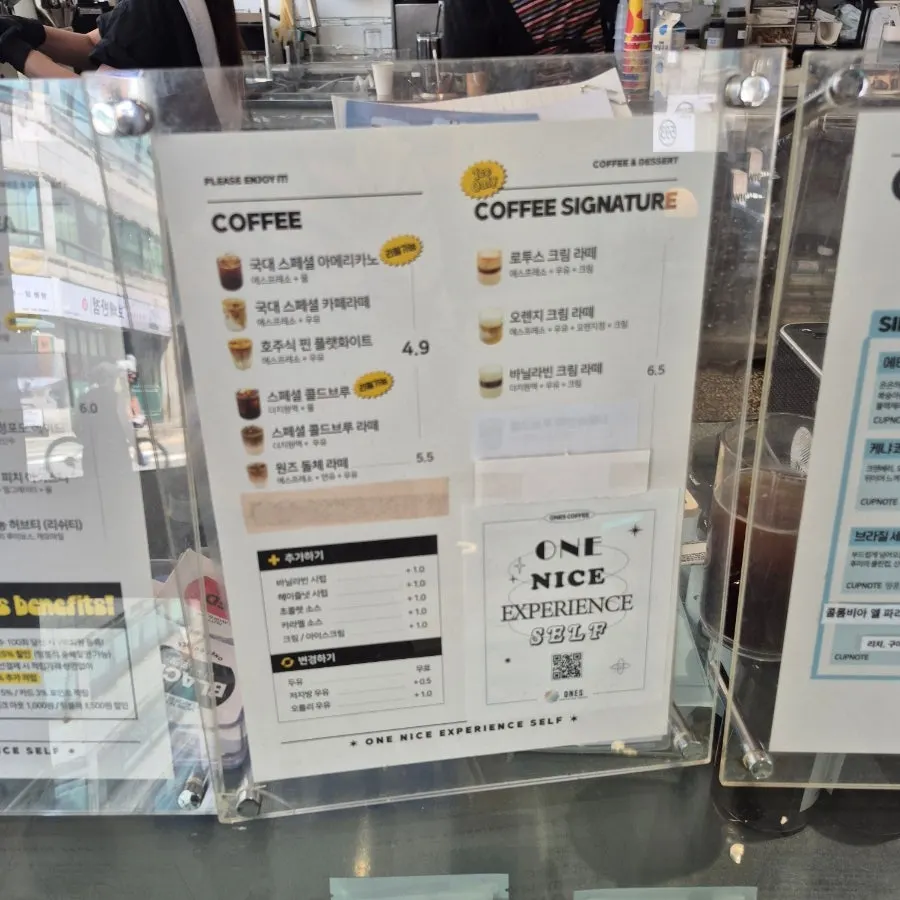 Menu board listing coffee and ade