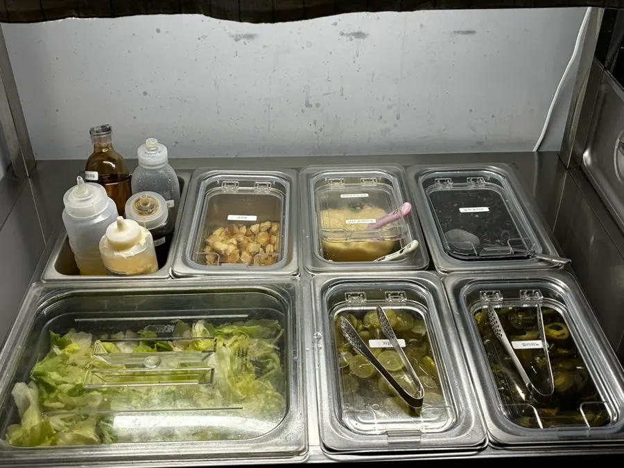 Self-serve salad bar and toppings station