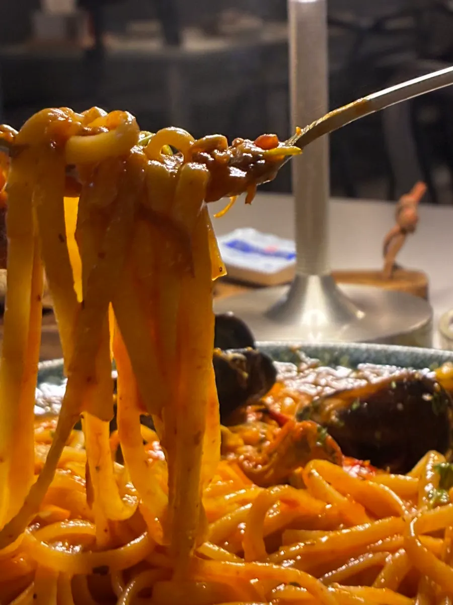 A bite of mushroom scooped up with sauce