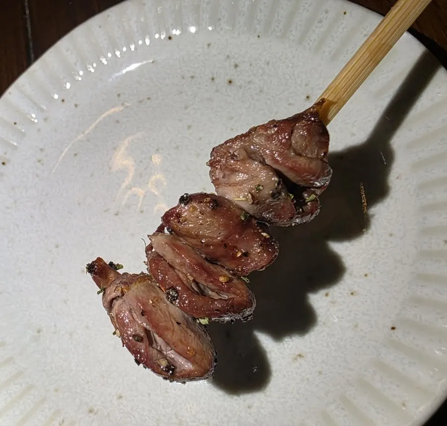 Three yakitori skewers: seseri, hatsu, and momo