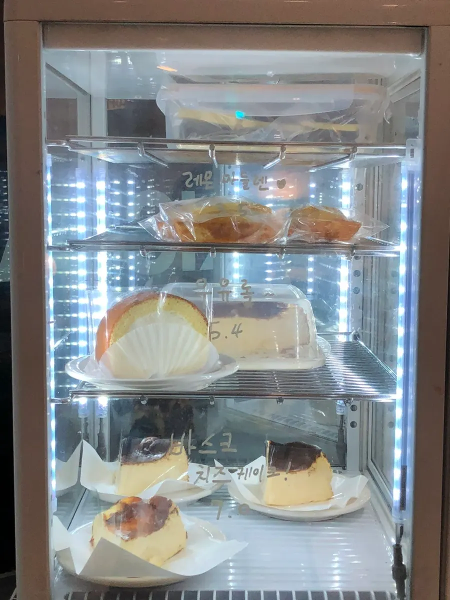 Display case of scones, cookies, and financiers