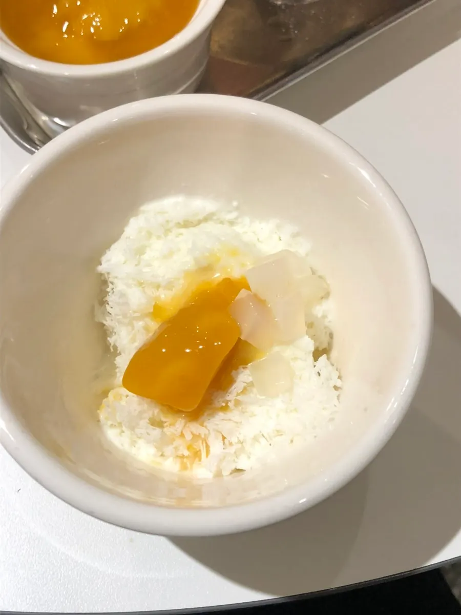 A spoonful of bingsu piled with mango
