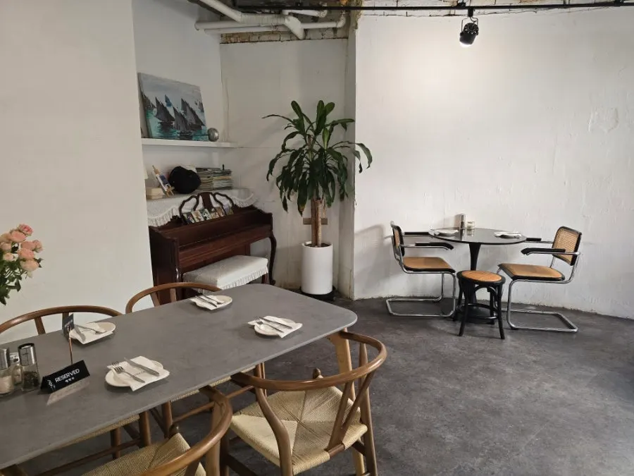 Main space with white walls and a large picture window