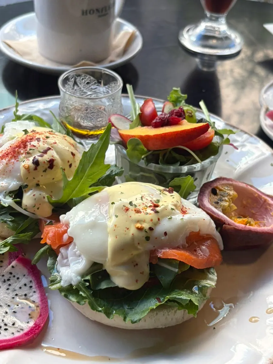 Eggs Benedict served with mini salad and tropical fruit