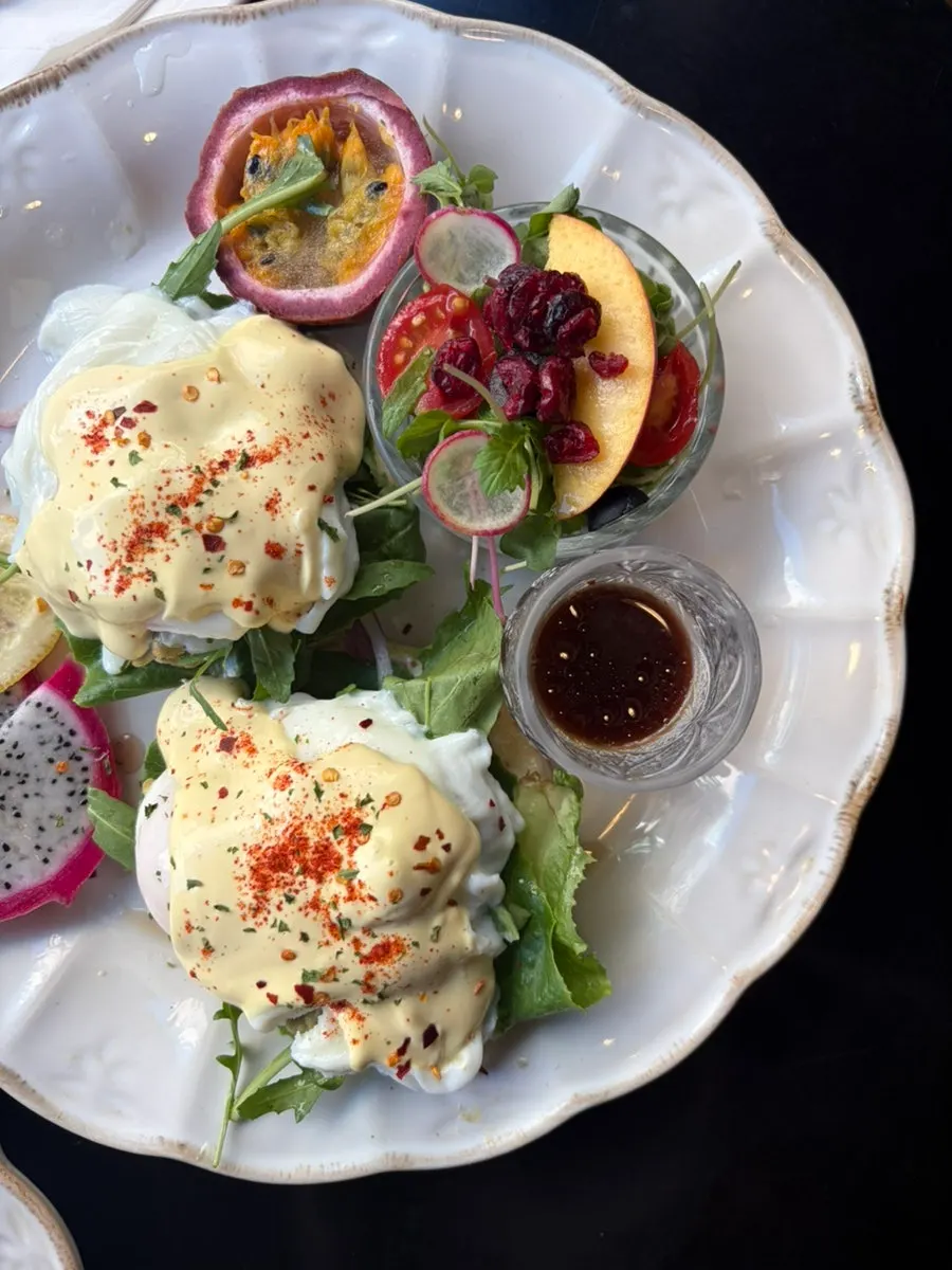 Close-up of a poached egg topped with lemon-bright hollandaise sauce