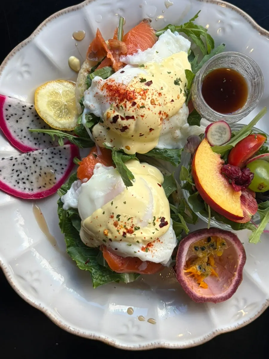 Cross-section of eggs Benedict on toasted bread