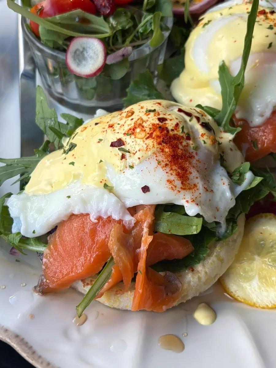Close-up of eggs Benedict topped with smoked salmon