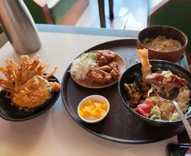 A bite of shrimp tempura on rice