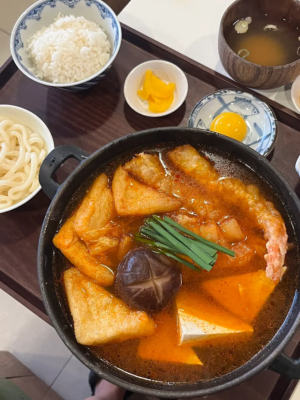 Spicy tempura kimchi nabe bubbling on the stove