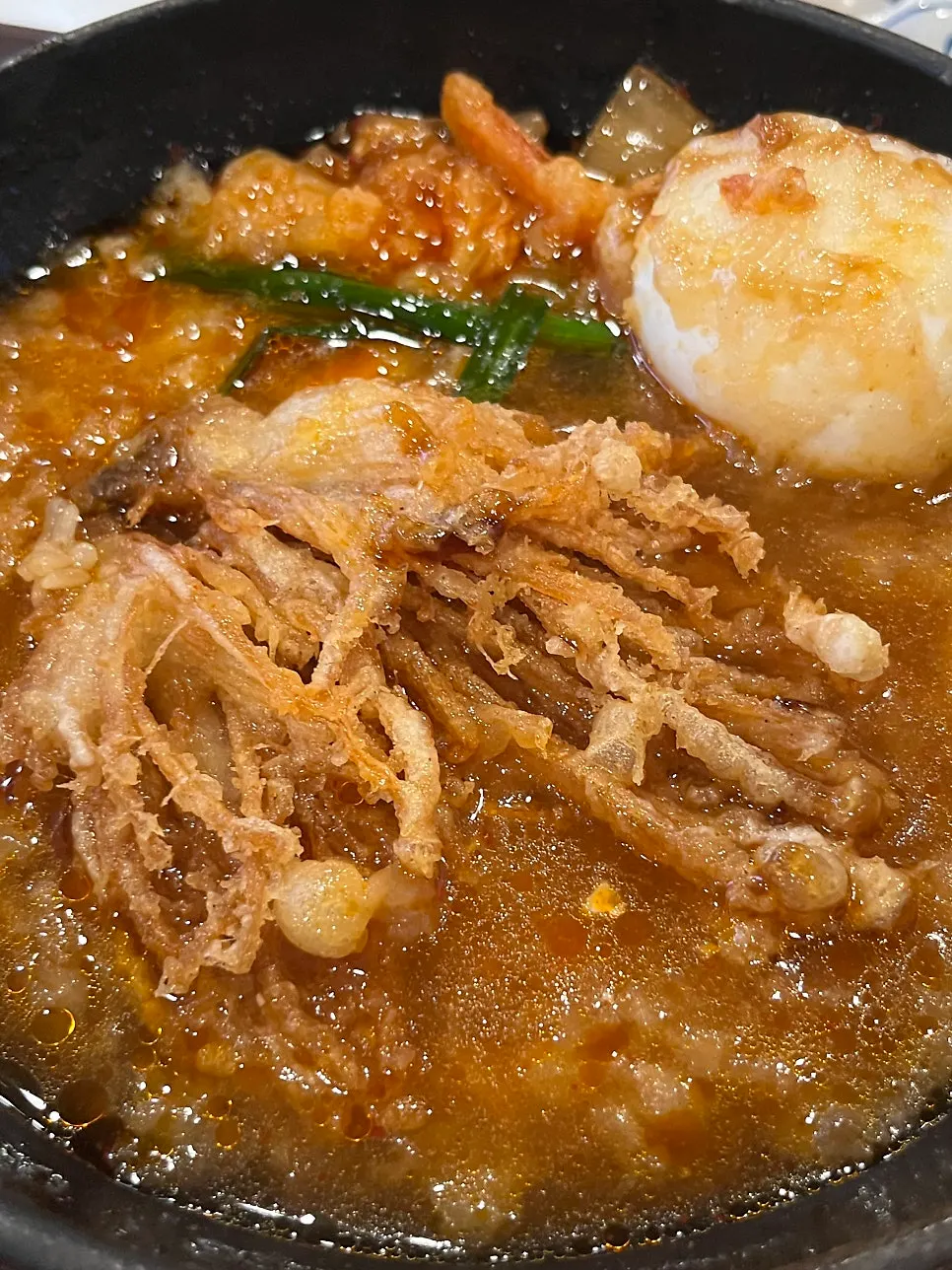 Tendon tempura dropped into the kimchi nabe
