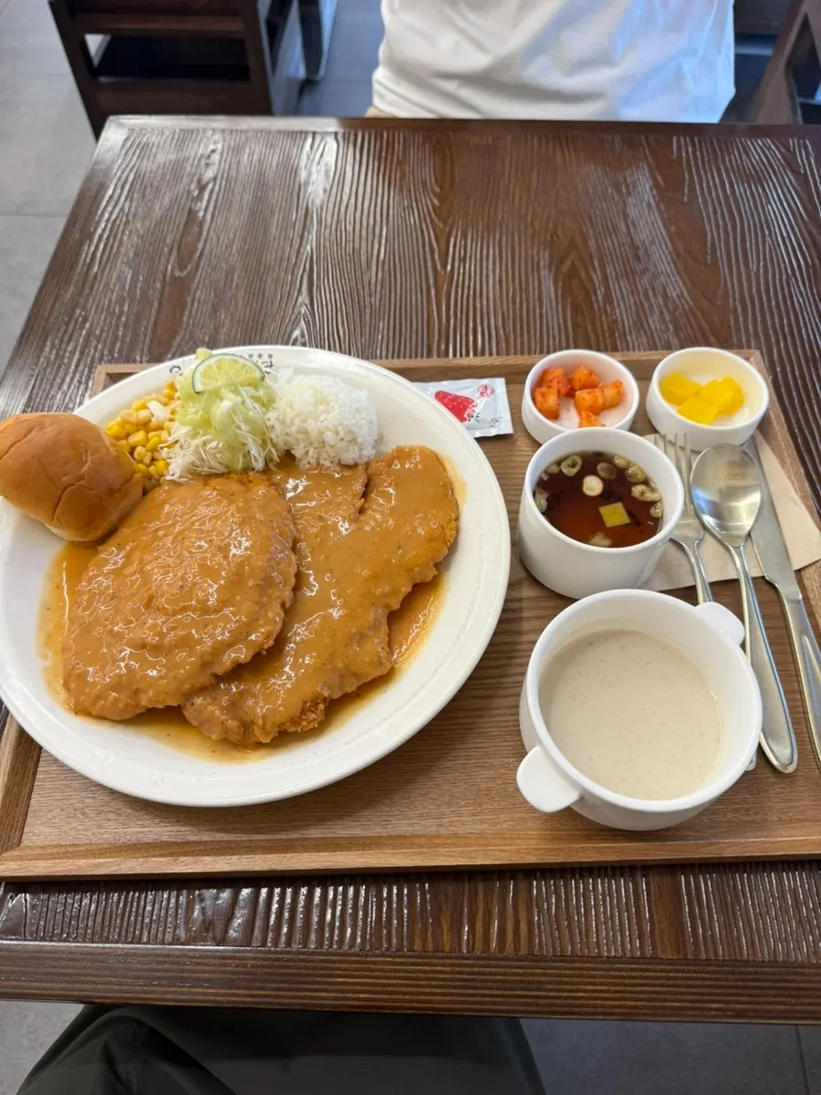 A full spread with pork cutlet, soup, mushroom soup, and bread