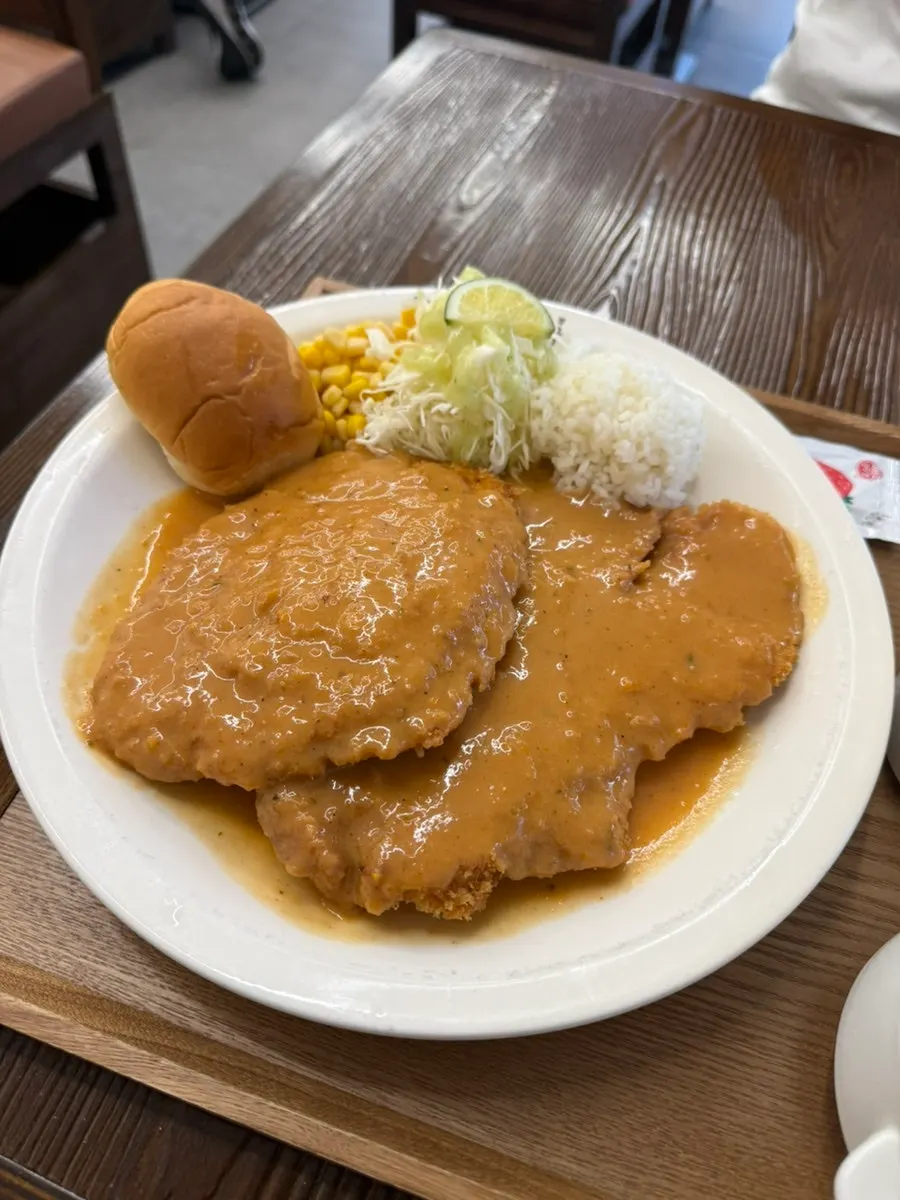 A plate of gyeongyangsik pork cutlet topped with sauce