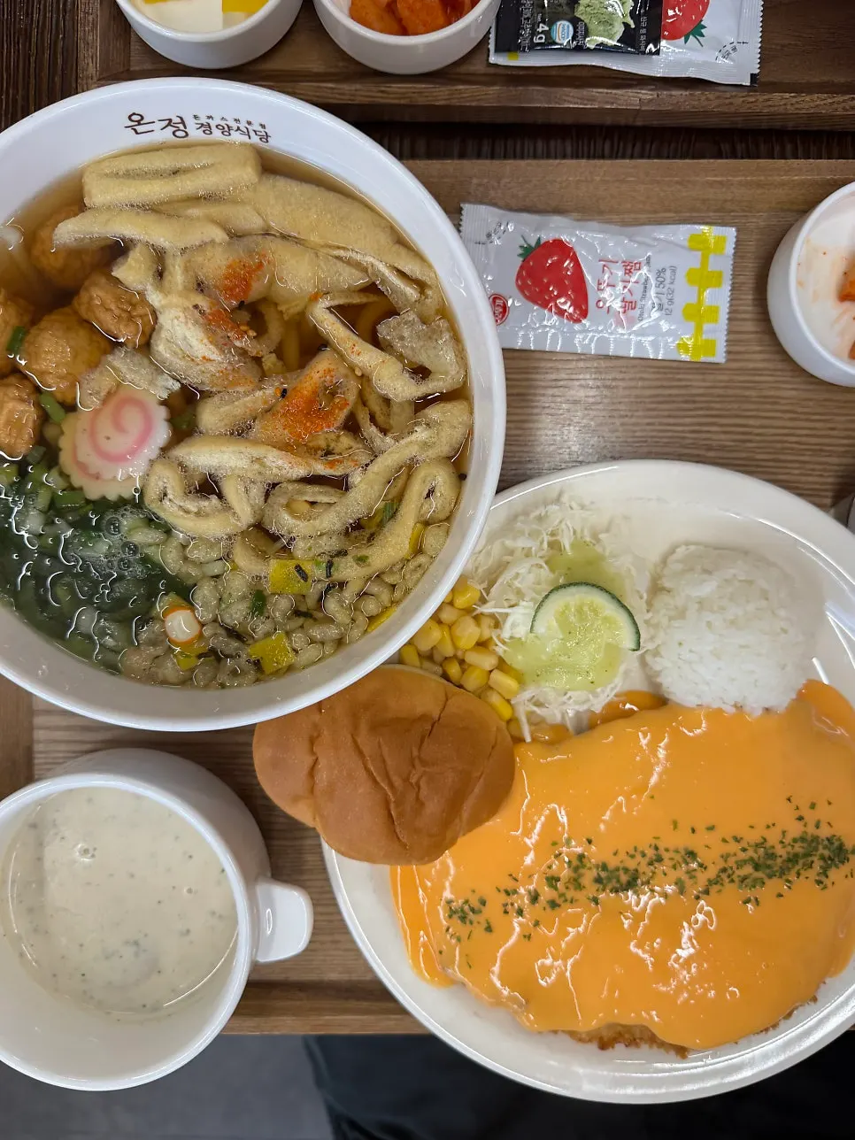 Cutlet topped with generous cheddar cheese sauce alongside udon