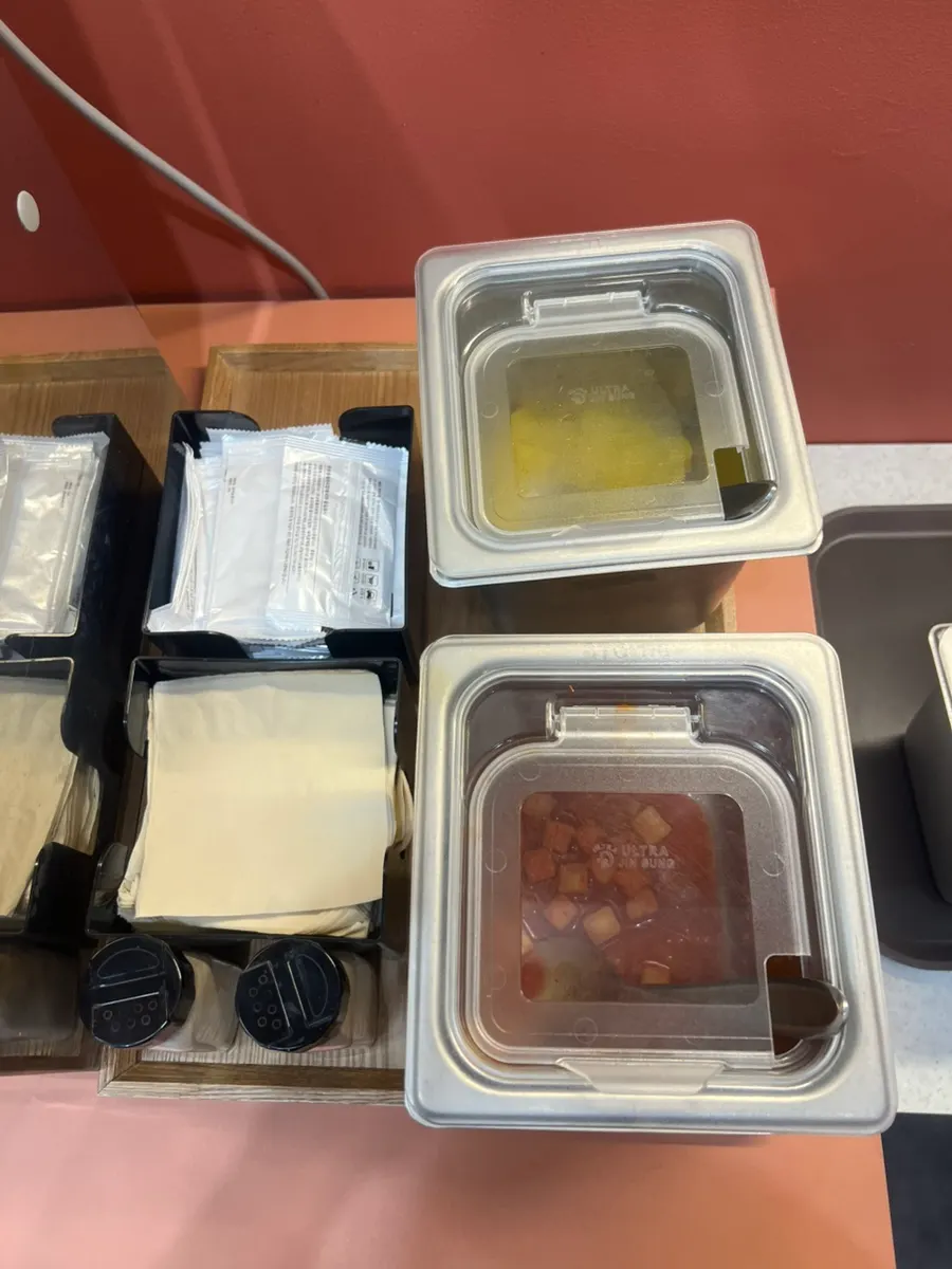 Self bar corner with tableware and sauces