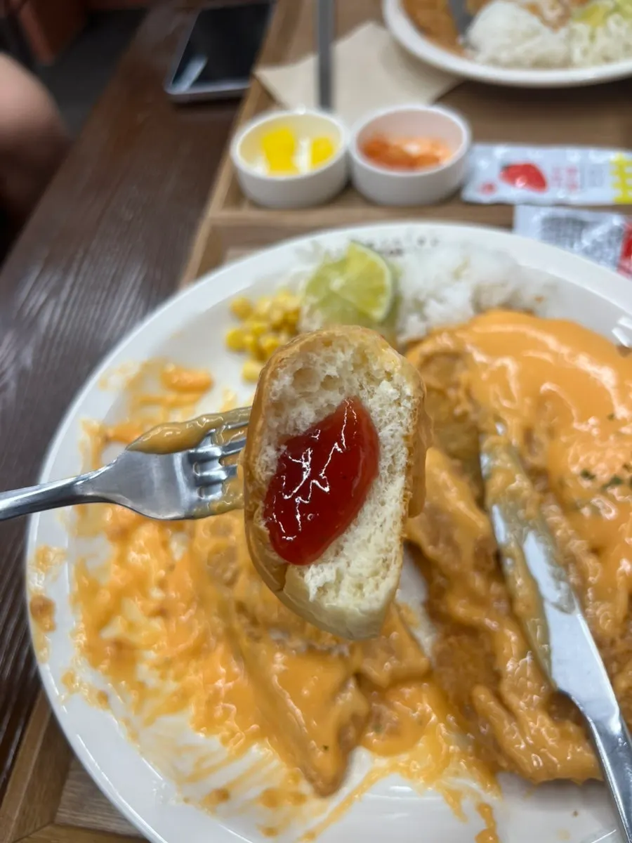 Rolls and strawberry jam served with the cutlet