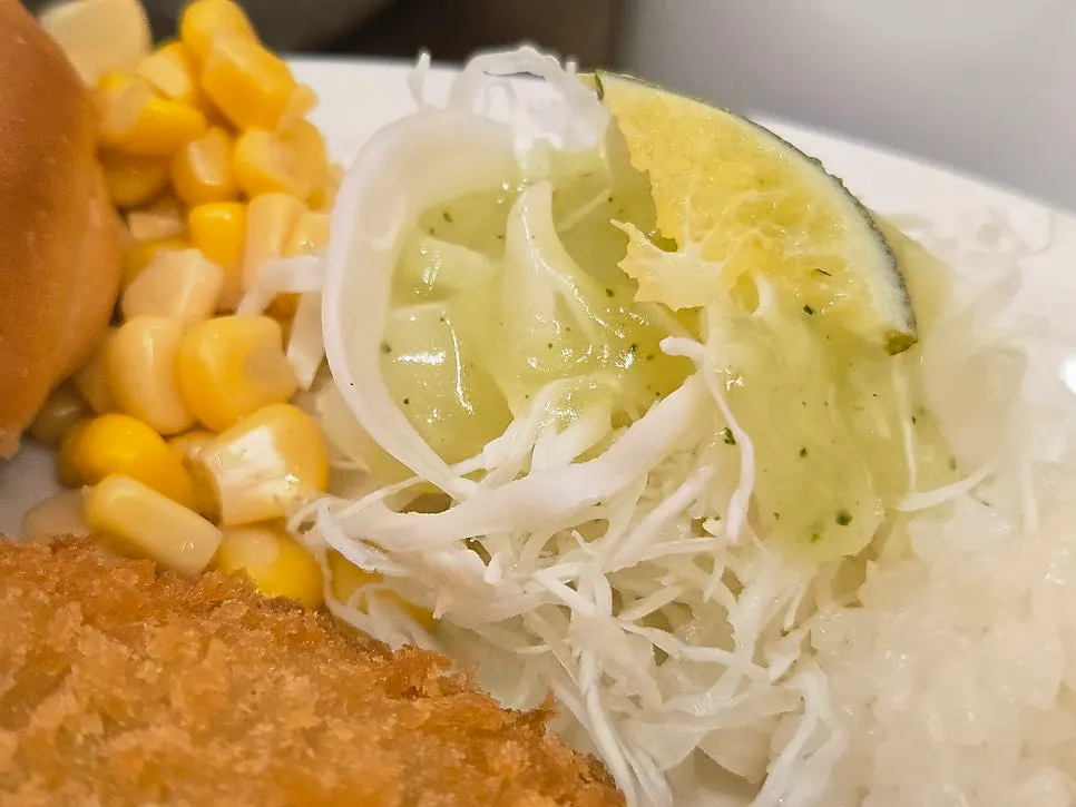 매콤한 소스를 찍은 돈까스 조각
