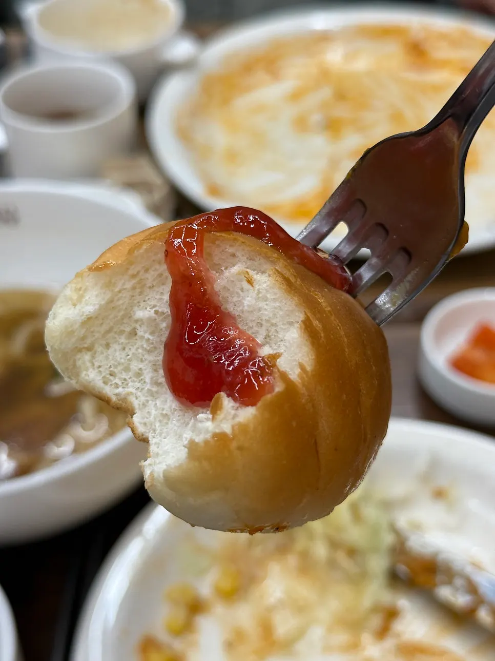 Dinner roll finished with strawberry jam